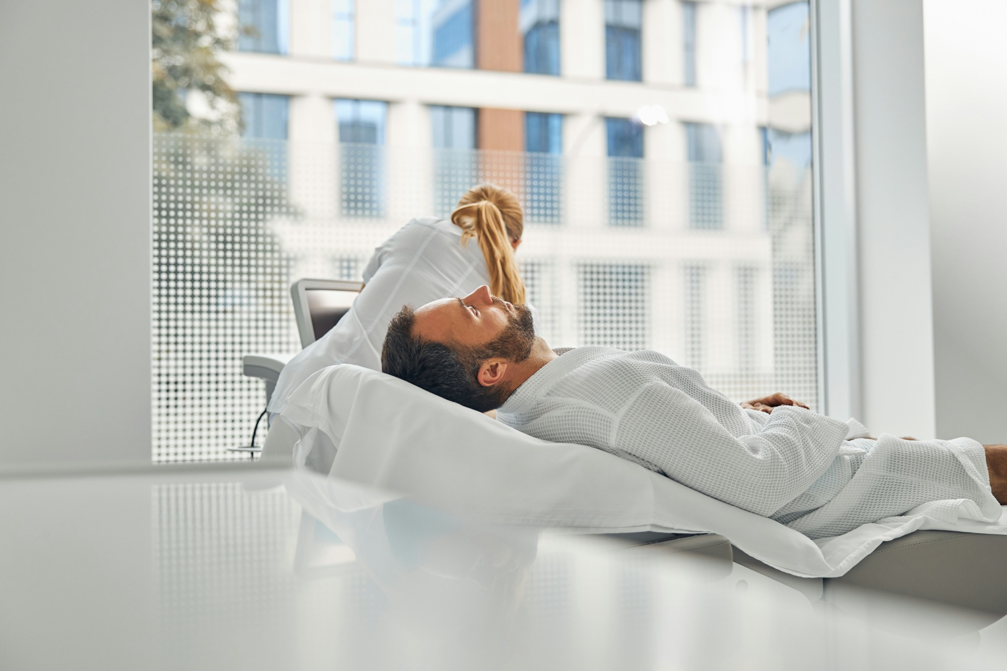 Prototype photograph of a patient during an assessment in a bright clinical setting.